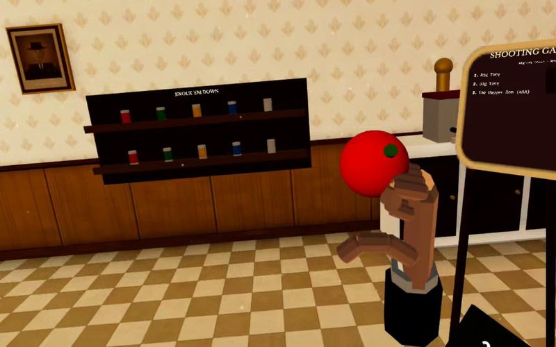 A ball in hand at the Knock ’Em Down shooting gallery with a shelf of cans